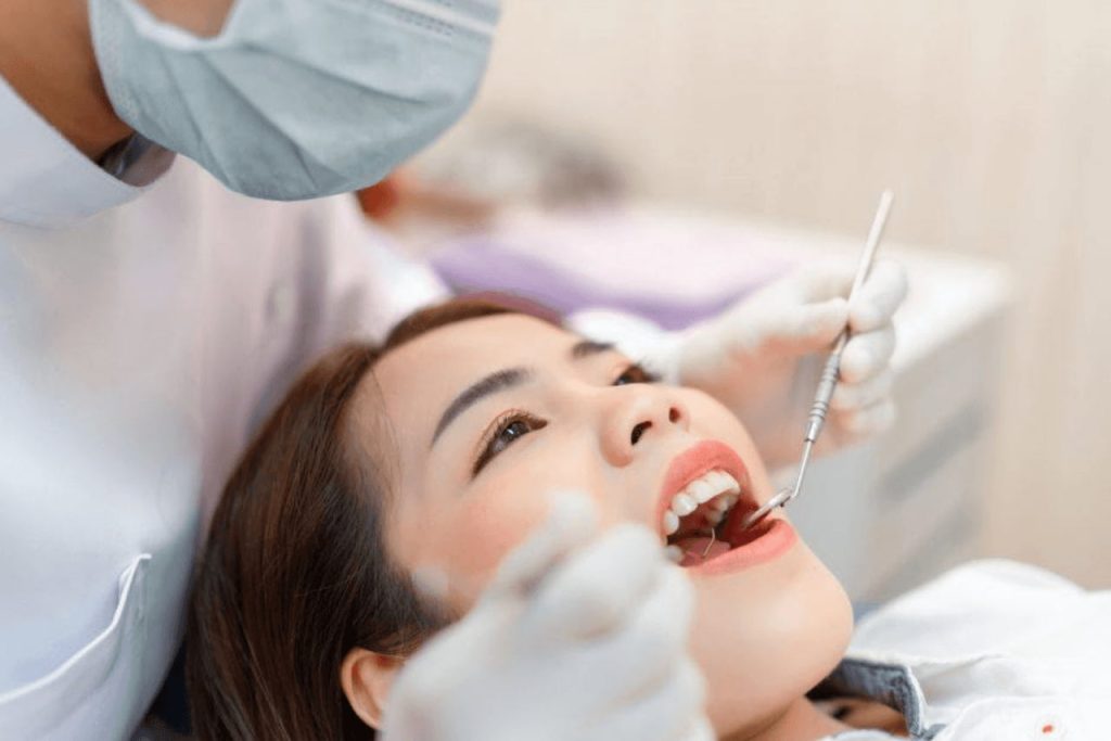 Dentist checking patient's teeth